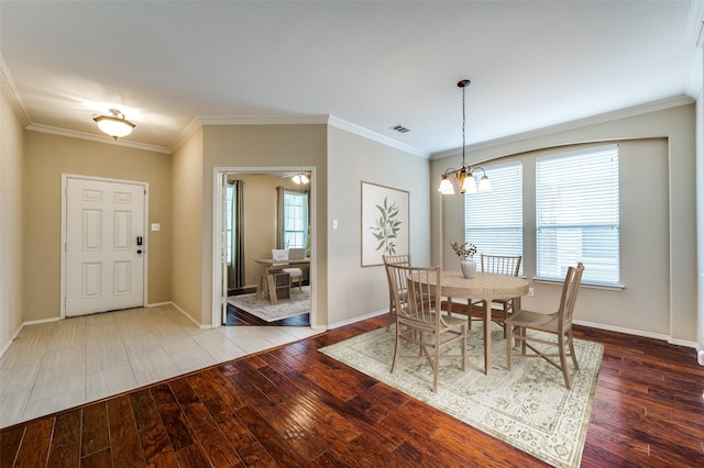 2748 Indian Oak Dr, Mckinney, TX 75071 - dining room with hardwood / wood-style flooring, crown molding, and a chandelier