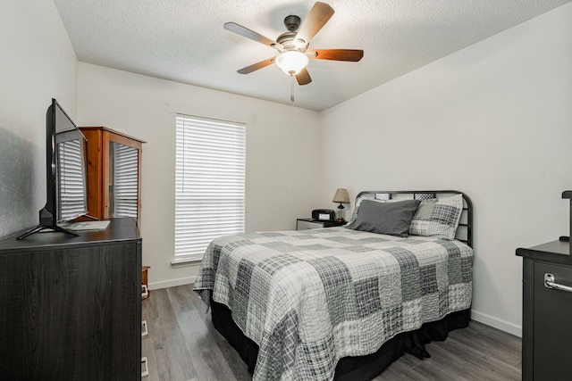 3615 7th St, Sachse, TX 75048 - bedroom featuring wood finished floors, a ceiling fan, and a textured ceiling