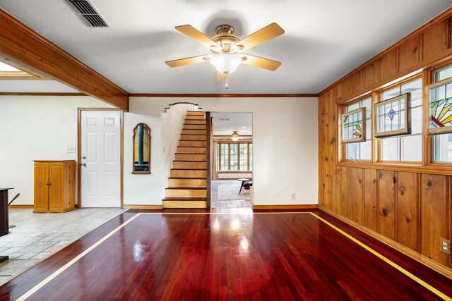 1933 E Hickory Hill Rd, Argyle, TX 76226 - unfurnished living room featuring a ceiling fan, wood finished floors, stairway, crown molding, and wood walls