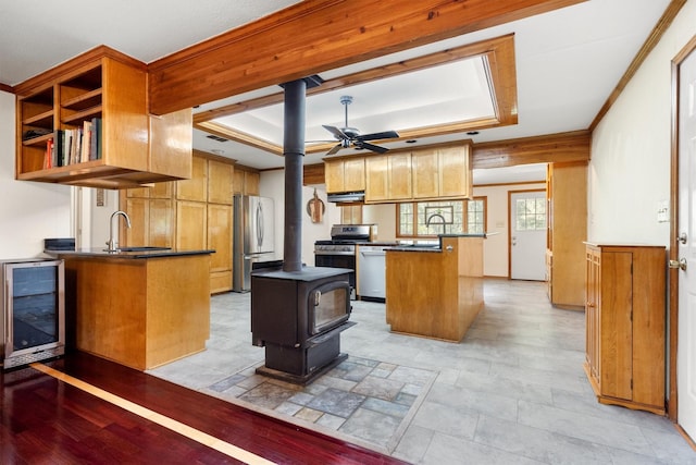 1933 E Hickory Hill Rd, Argyle, TX 76226 - kitchen featuring appliances with stainless steel finishes, wine cooler, ceiling fan, dark countertops, and a peninsula