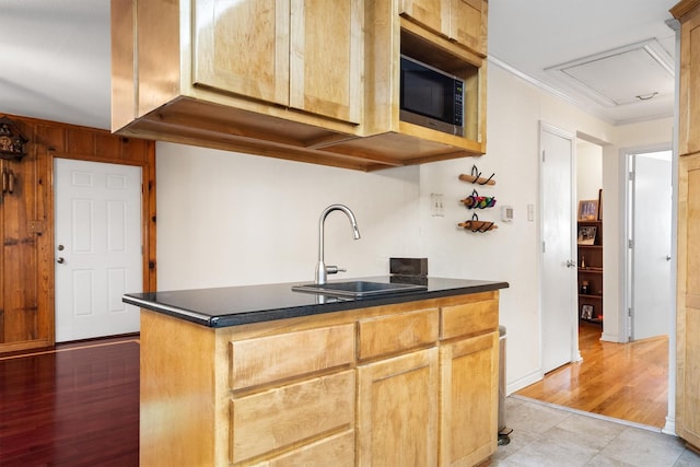 1933 E Hickory Hill Rd, Argyle, TX 76226 - kitchen with stainless steel microwave, dark countertops, crown molding, and light wood-type flooring