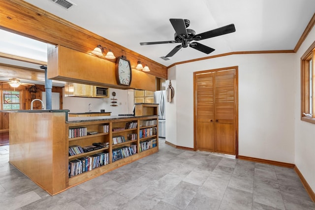 1933 E Hickory Hill Rd, Argyle, TX 76226 - kitchen with ceiling fan, appliances with stainless steel finishes, dark countertops, crown molding, and vaulted ceiling