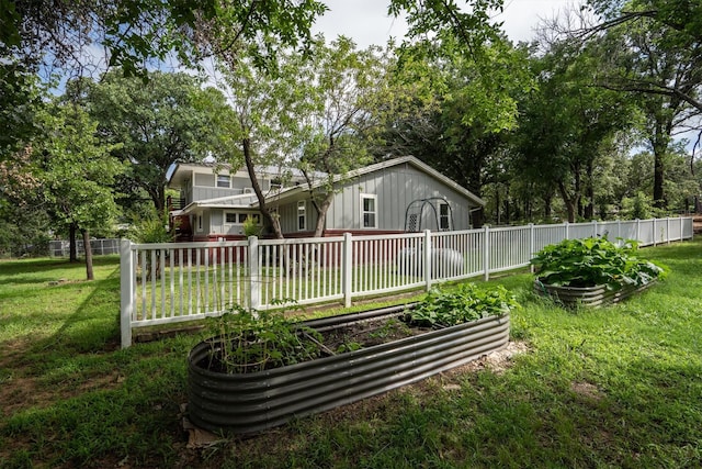1933 E Hickory Hill Rd, Argyle, TX 76226 - rear view of property featuring a vegetable garden and board and batten siding