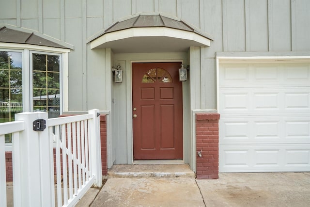 1933 E Hickory Hill Rd, Argyle, TX 76226 - view of exterior entry featuring a garage, board and batten siding, and brick siding