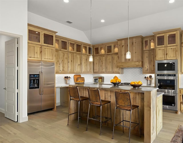 3148 Bryne Ln, Rockwall, TX 75087 - kitchen with stainless steel appliances, light wood-style floors, a center island, decorative backsplash, and recessed lighting