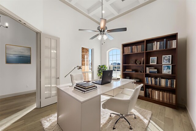 3148 Bryne Ln, Rockwall, TX 75087 - home office featuring a towering ceiling, beamed ceiling, light wood-type flooring, coffered ceiling, and ceiling fan