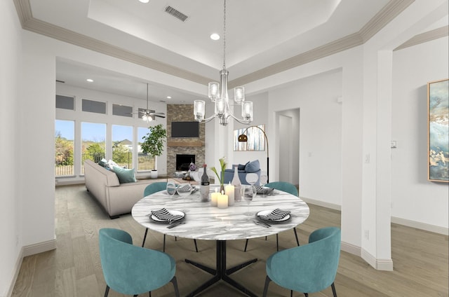 3148 Bryne Ln, Rockwall, TX 75087 - dining room with a raised ceiling, a fireplace, recessed lighting, light wood-style floors, and ceiling fan