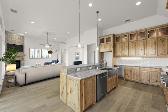 3148 Bryne Ln, Rockwall, TX 75087 - kitchen with a fireplace, dishwasher, open floor plan, light wood-style floors, and recessed lighting