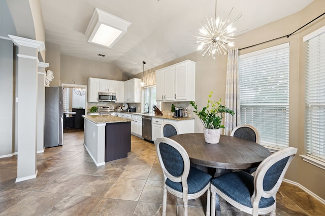 1608 Highland Oaks Dr, Keller, TX 76248 - kitchen with appliances with stainless steel finishes, a chandelier, vaulted ceiling, a center island, and white cabinetry