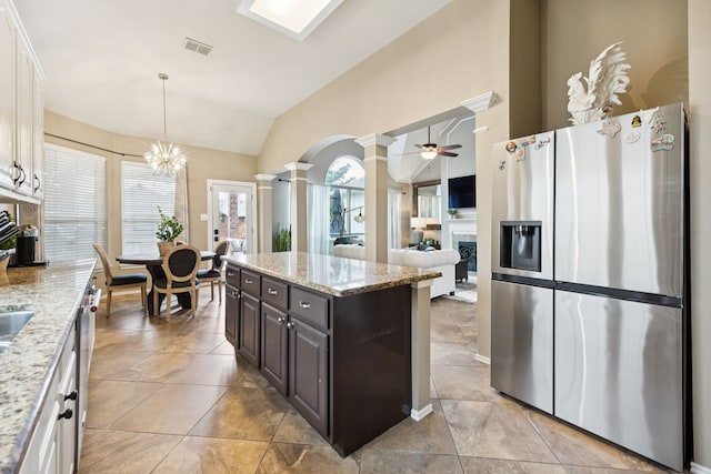1608 Highland Oaks Dr, Keller, TX 76248 - kitchen with stainless steel refrigerator with ice dispenser, ornate columns, a fireplace, lofted ceiling, and ceiling fan