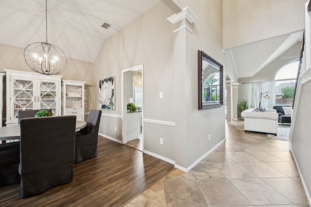 1608 Highland Oaks Dr, Keller, TX 76248 - dining space with a chandelier, high vaulted ceiling, decorative columns, and wood finished floors