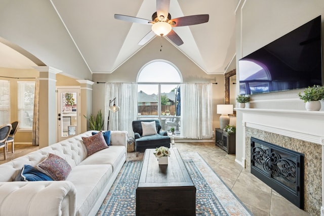1608 Highland Oaks Dr, Keller, TX 76248 - living room with ornate columns, a ceiling fan, a glass covered fireplace, healthy amount of natural light, and lofted ceiling