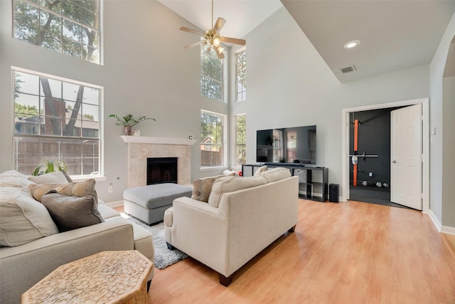 2525 Amber Ln, Flower Mound, TX 75028 - living area with high vaulted ceiling, a ceiling fan, light wood finished floors, and a fireplace