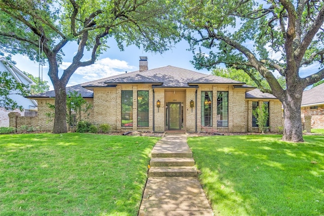 3404 Appalachian Way, Plano, TX 75075 - view of front of property featuring a chimney, a front yard, brick siding, and a shingled roof
