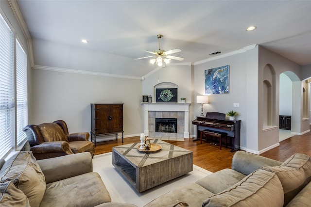 5628 Vineyard Ln, Mckinney, TX 75070 - living room featuring arched walkways, ceiling fan, wood finished floors, a fireplace, and lofted ceiling