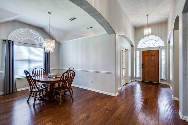 5628 Vineyard Ln, Mckinney, TX 75070 - dining room with a chandelier, hardwood / wood-style flooring, arched walkways, and vaulted ceiling