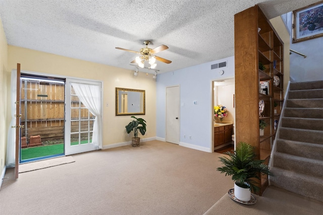 6503 Ridgecrest Rd Unit 107G, Dallas, TX 75231 - interior space featuring carpet flooring, stairs, ceiling fan, and a textured ceiling