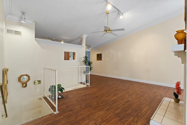 6503 Ridgecrest Rd Unit 107G, Dallas, TX 75231 - unfurnished living room featuring rail lighting, ornamental molding, a ceiling fan, a textured ceiling, and wood finished floors