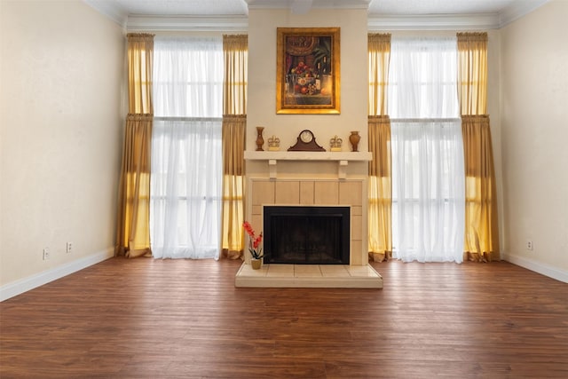 6503 Ridgecrest Rd Unit 107G, Dallas, TX 75231 - unfurnished living room with crown molding, a tiled fireplace, healthy amount of natural light, and wood finished floors