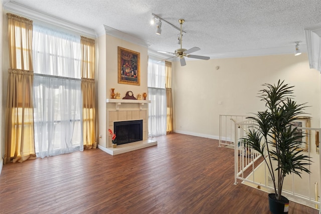 6503 Ridgecrest Rd Unit 107G, Dallas, TX 75231 - living area featuring track lighting, a textured ceiling, crown molding, plenty of natural light, and a fireplace