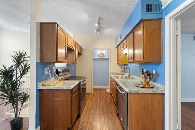 6503 Ridgecrest Rd Unit 107G, Dallas, TX 75231 - kitchen featuring stainless steel appliances, a textured ceiling, light countertops, wood finished floors, and brown cabinets