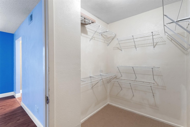 6503 Ridgecrest Rd Unit 107G, Dallas, TX 75231 - walk in closet with wood finished floors