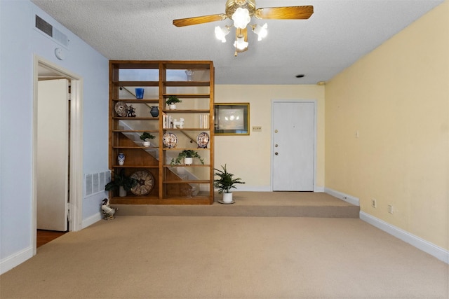 6503 Ridgecrest Rd Unit 107G, Dallas, TX 75231 - entryway featuring carpet floors, a ceiling fan, and a textured ceiling