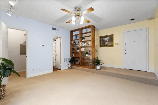 6503 Ridgecrest Rd Unit 107G, Dallas, TX 75231 - living area with carpet floors, a ceiling fan, a textured ceiling, and electric panel