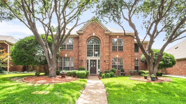 6740 Magnum Dr, Plano, TX 75024 - view of front of house with brick siding and a front lawn