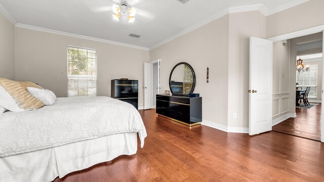 6740 Magnum Dr, Plano, TX 75024 - bedroom featuring wood finished floors, crown molding, and a chandelier