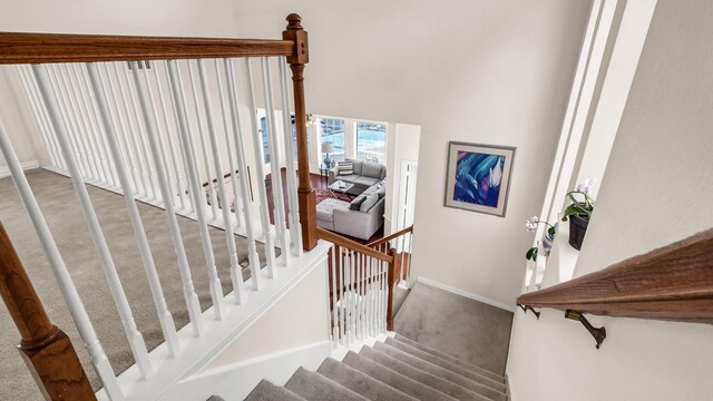 6740 Magnum Dr, Plano, TX 75024 - staircase featuring carpet and a high ceiling