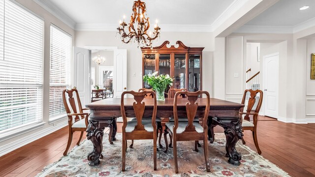 6740 Magnum Dr, Plano, TX 75024 - dining area featuring a chandelier, hardwood / wood-style floors, stairway, and ornamental molding