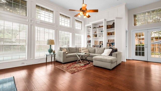 6740 Magnum Dr, Plano, TX 75024 - living area with plenty of natural light, a ceiling fan, dark wood-style flooring, a towering ceiling, and built in features