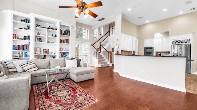 6740 Magnum Dr, Plano, TX 75024 - living area featuring a ceiling fan, wood finished floors, stairs, a high ceiling, and recessed lighting