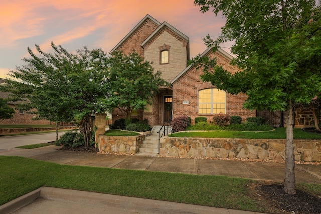 8240 Odell St, North Richland Hills, TX 76182 - tudor home featuring brick siding and a front yard