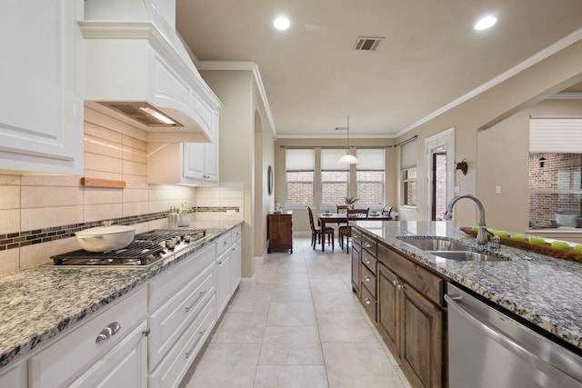 8240 Odell St, North Richland Hills, TX 76182 - kitchen with appliances with stainless steel finishes, tasteful backsplash, white cabinetry, ornamental molding, and recessed lighting