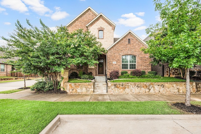 8240 Odell St, North Richland Hills, TX 76182 - view of front facade with brick siding and a front lawn