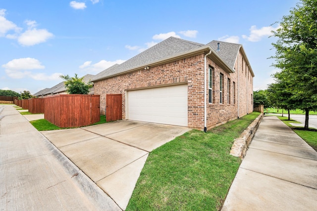 8240 Odell St, North Richland Hills, TX 76182 - view of home's exterior with a shingled roof, driveway, brick siding, and an attached garage