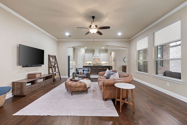 8240 Odell St, North Richland Hills, TX 76182 - living room with arched walkways, dark wood-style flooring, crown molding, a ceiling fan, and recessed lighting