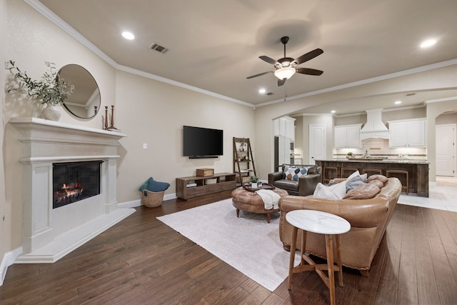 8240 Odell St, North Richland Hills, TX 76182 - living room featuring a ceiling fan, dark wood-style flooring, a glass covered fireplace, arched walkways, and recessed lighting