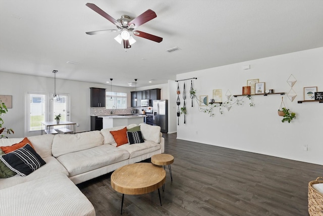 9009 Benevolent Ct, Providence Village, TX 76227 - living area featuring dark wood-type flooring and a ceiling fan