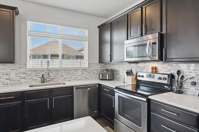 9009 Benevolent Ct, Providence Village, TX 76227 - kitchen featuring stainless steel appliances, light countertops, and decorative backsplash
