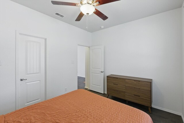 9009 Benevolent Ct, Providence Village, TX 76227 - bedroom featuring a ceiling fan and dark wood-type flooring