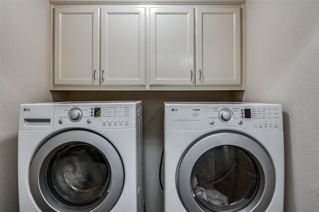 17342 Remington Park Pl, Dallas, TX 75252 - laundry area featuring washing machine and dryer and cabinet space