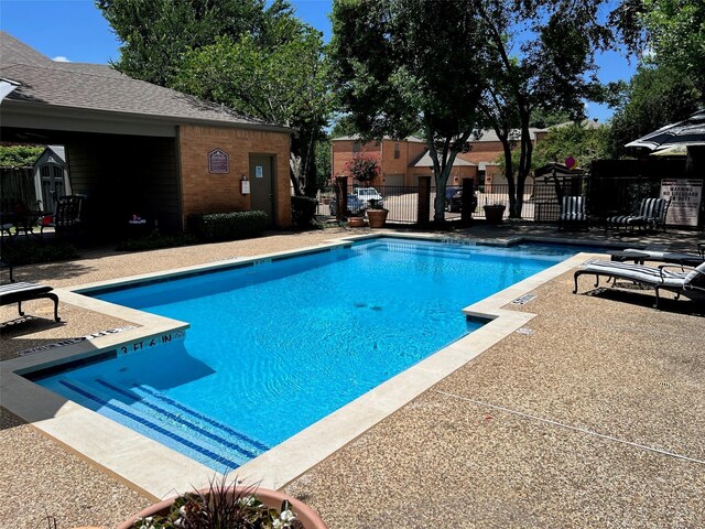 17342 Remington Park Pl, Dallas, TX 75252 - view of swimming pool featuring a storage unit and a patio area