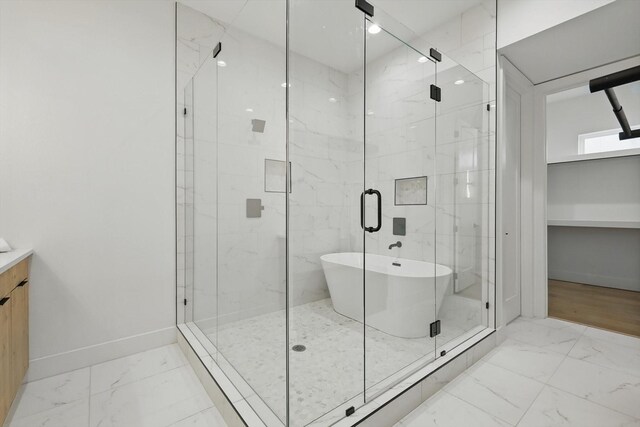 4208 Live Oak St Unit 102, Dallas, TX 75204 - bathroom with marble finish floors, a freestanding tub, and a marble finish shower