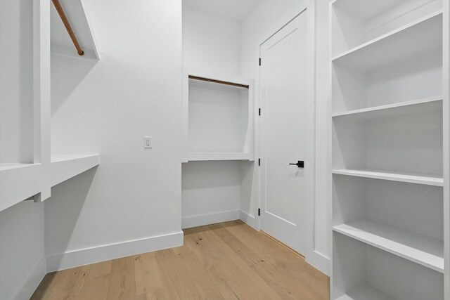 4208 Live Oak St Unit 102, Dallas, TX 75204 - walk in closet featuring wood finished floors