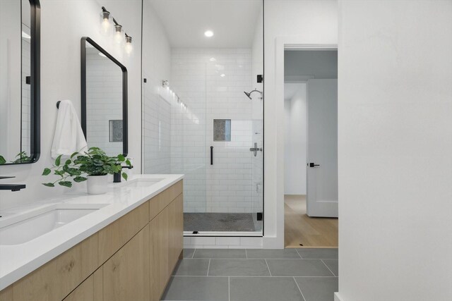 4208 Live Oak St Unit 102, Dallas, TX 75204 - bathroom with double vanity, tile patterned floors, a stall shower, and recessed lighting
