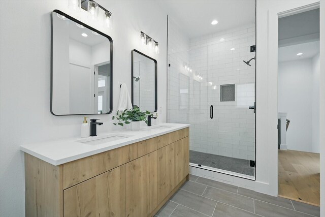 4208 Live Oak St Unit 102, Dallas, TX 75204 - bathroom featuring double vanity, a stall shower, tile patterned floors, and recessed lighting