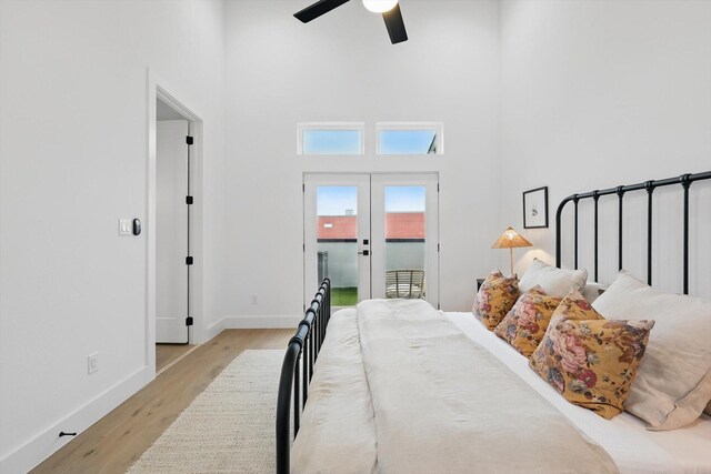 4208 Live Oak St Unit 102, Dallas, TX 75204 - bedroom with a high ceiling, wood finished floors, access to outside, ceiling fan, and french doors